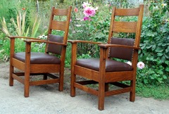 Pair of Stickley Brothers bow-arm chairs.